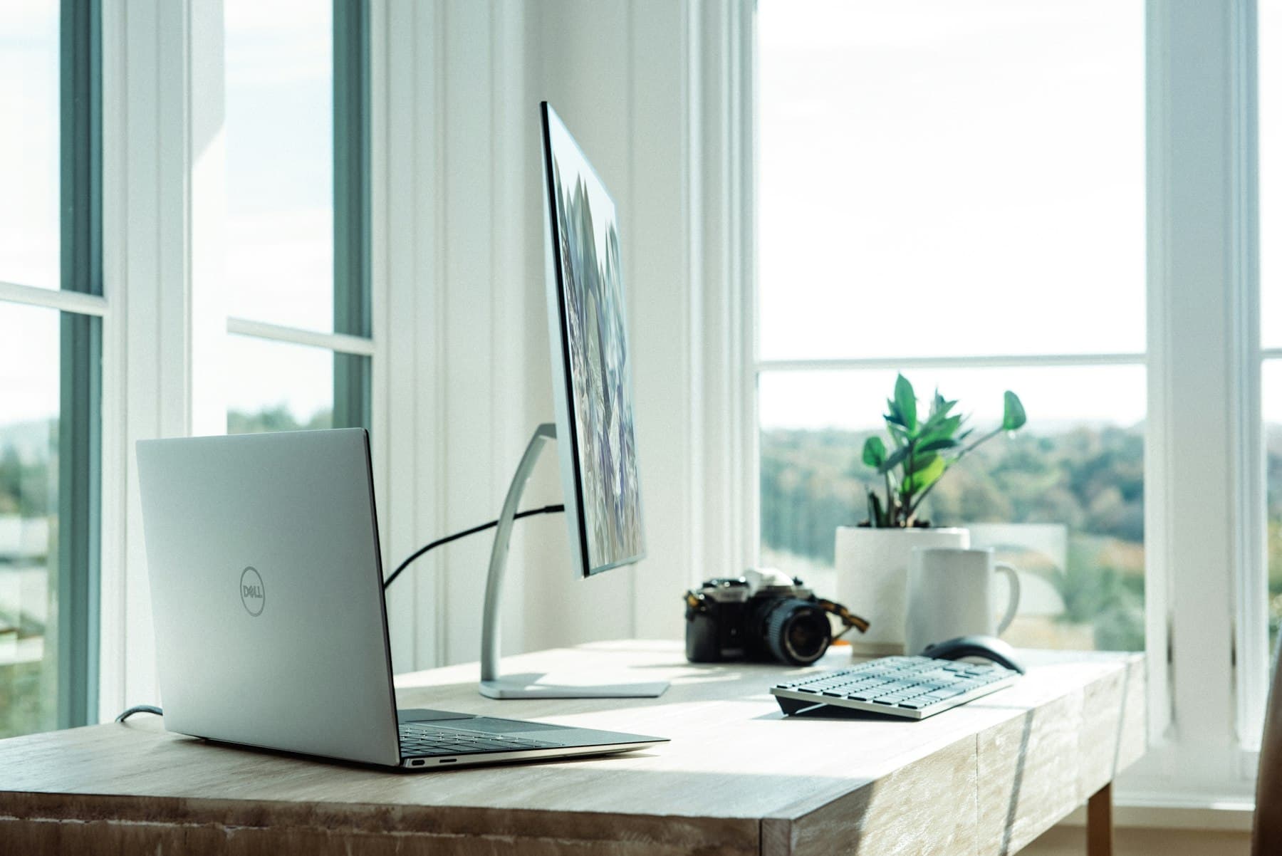 A laptop on a clean desk by a bright window, ready for free AI resources and the free C1 course